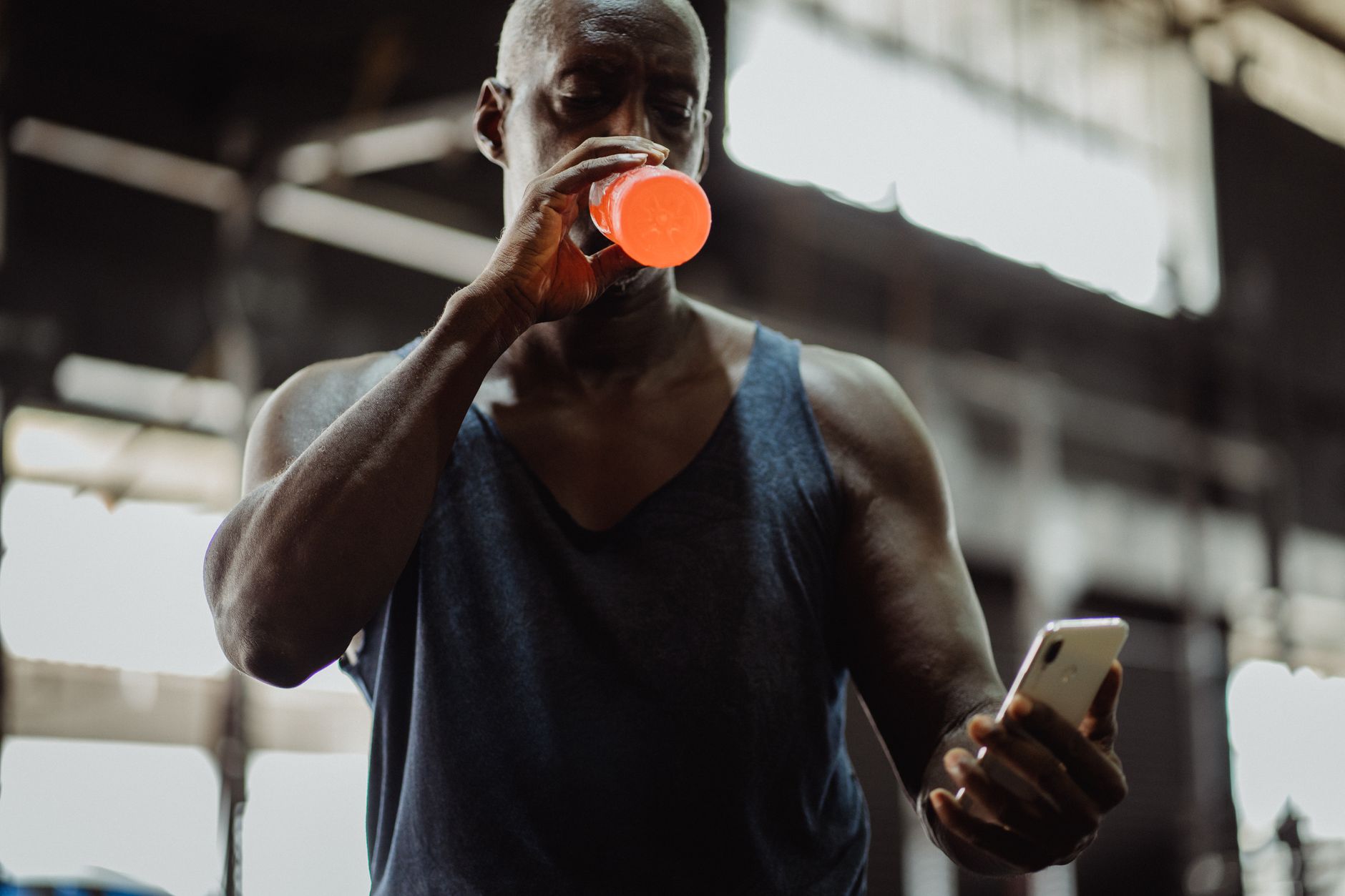 Athlete checking a fitness app on a phone for Best app for regenerating training plans without duplicate workouts.
