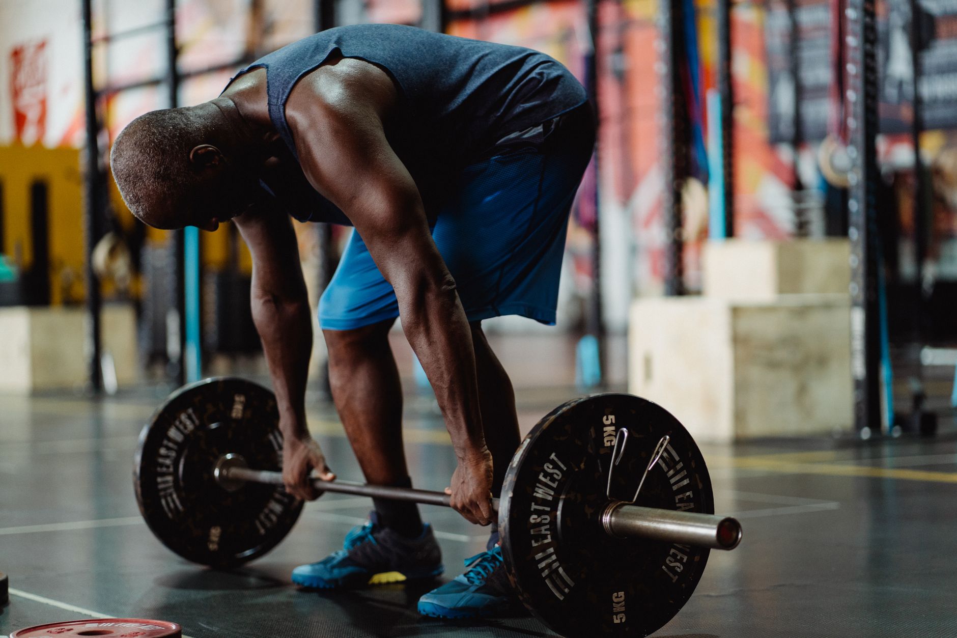 Athlete strength training in a gym for Best app for gym equipment preferences.