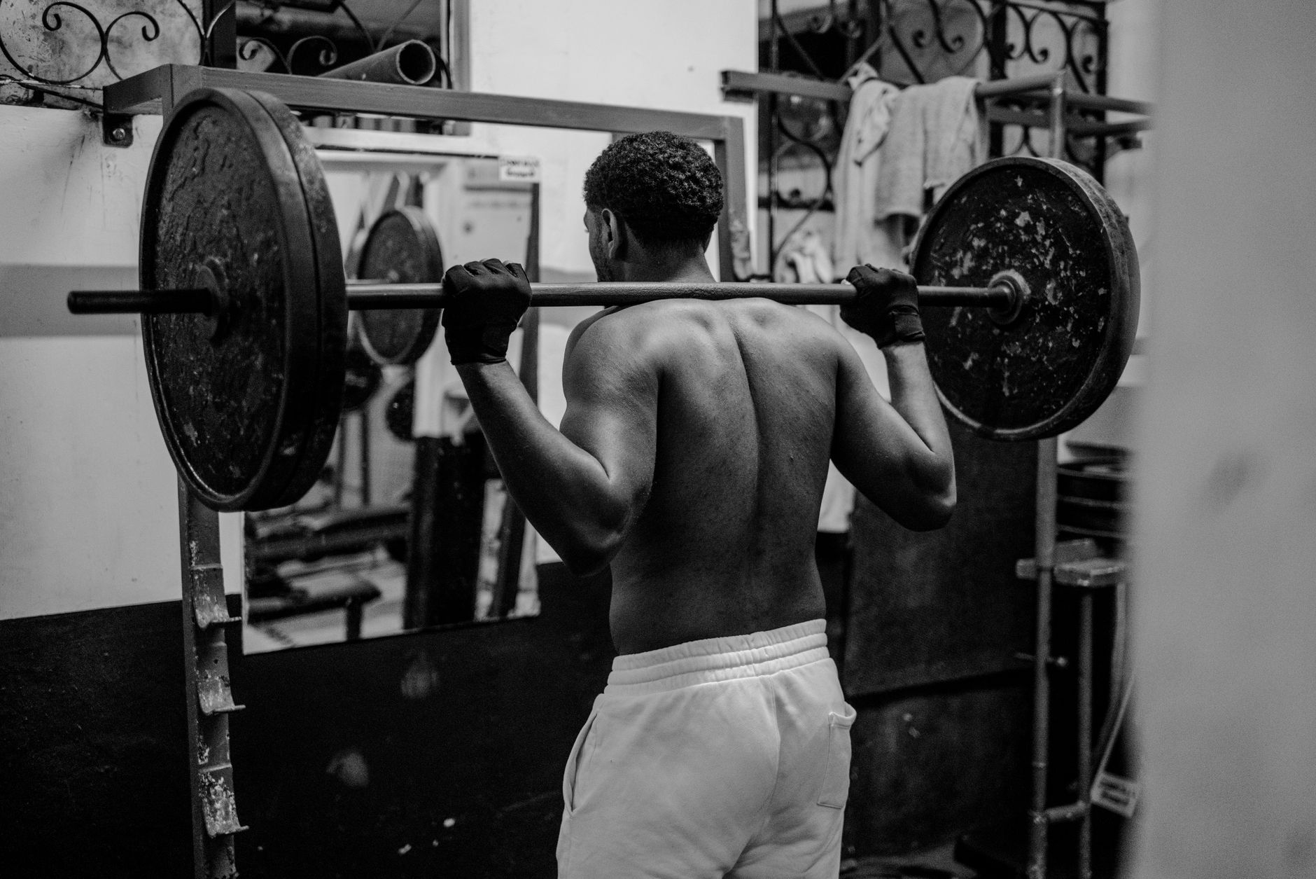 Athlete strength training in a gym for Best app for exercise-focused strength workouts.