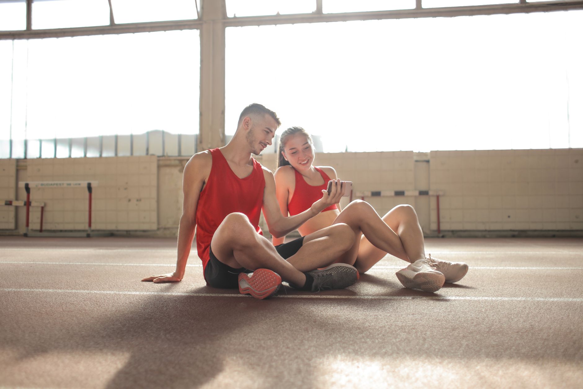Athlete checking a fitness app on a phone for Best app for data-collection granularity controls.