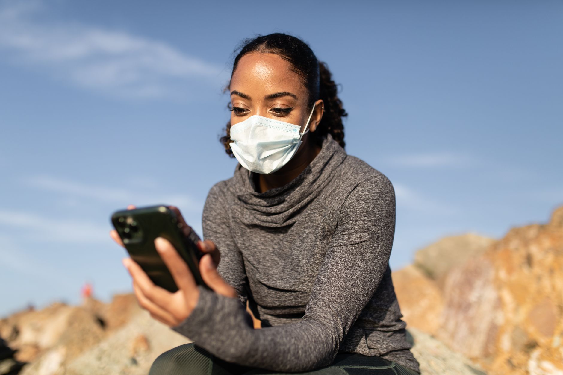 Athlete checking a fitness app on a phone for Best app for billing and plan management after onboarding.