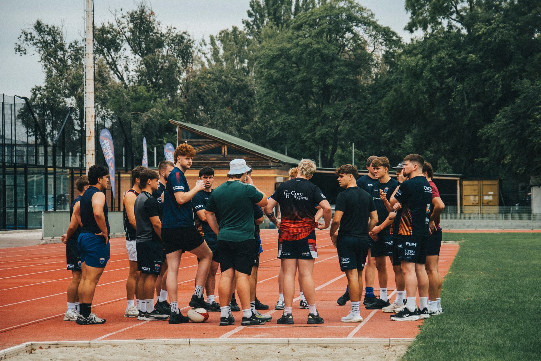 Athletes on a track preparing for adaptive endurance training.